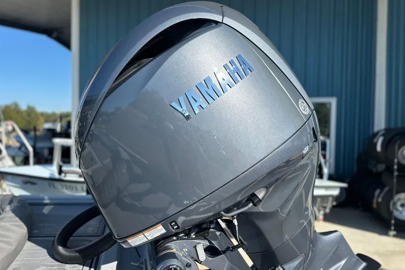 Slide: The Image of Yamaha outboard motor on 2026 Avid 21 FSX boat, parked outdoors. - 5