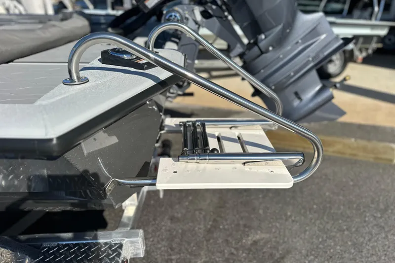 Slide: The Image of Avid 21 FSX 2026 boat with stainless steel swim ladder and motor in background. - 7