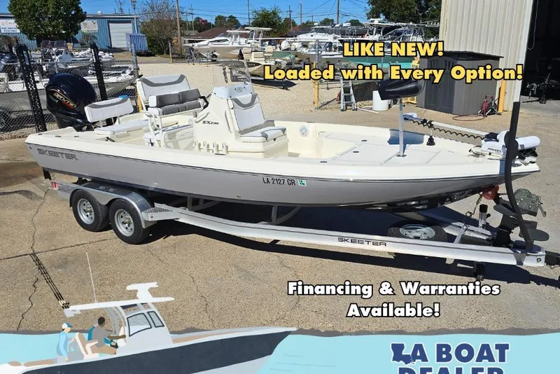 Slide: The Image of 2023 Skeeter SX230 boat on trailer, available with financing and warranties. - 0