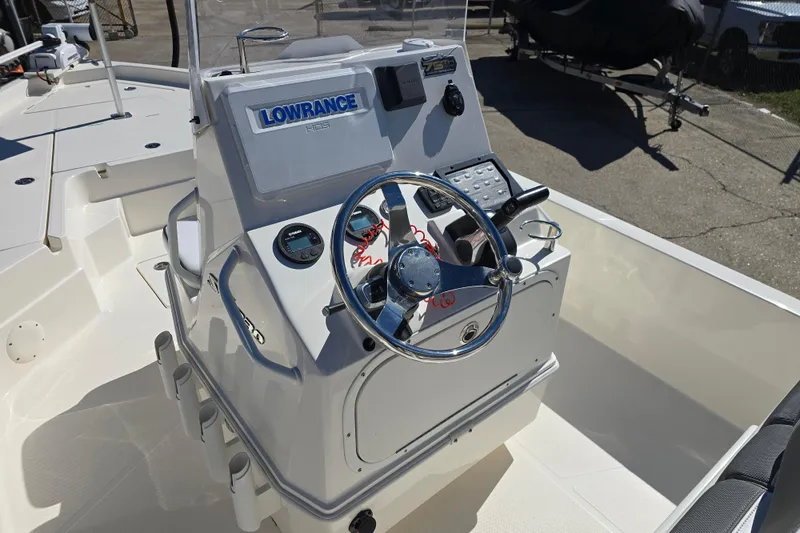 Slide: The Image of 2023 Skeeter SX230 boat console with Lowrance electronics and steering wheel. - 11