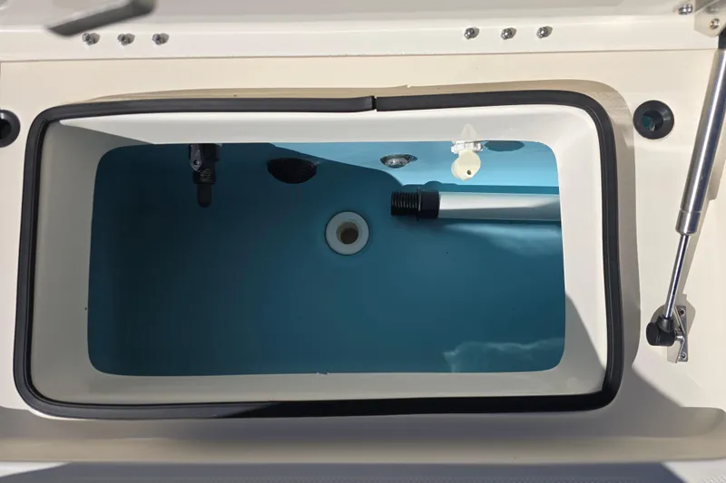 Slide: The Image of Livewell compartment of 2023 Skeeter SX230 boat, featuring a clean interior and secure lid. - 14