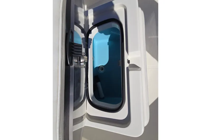 Slide: The Image of 2023 Skeeter SX230 boat compartment with open lid, showcasing interior storage space. - 17