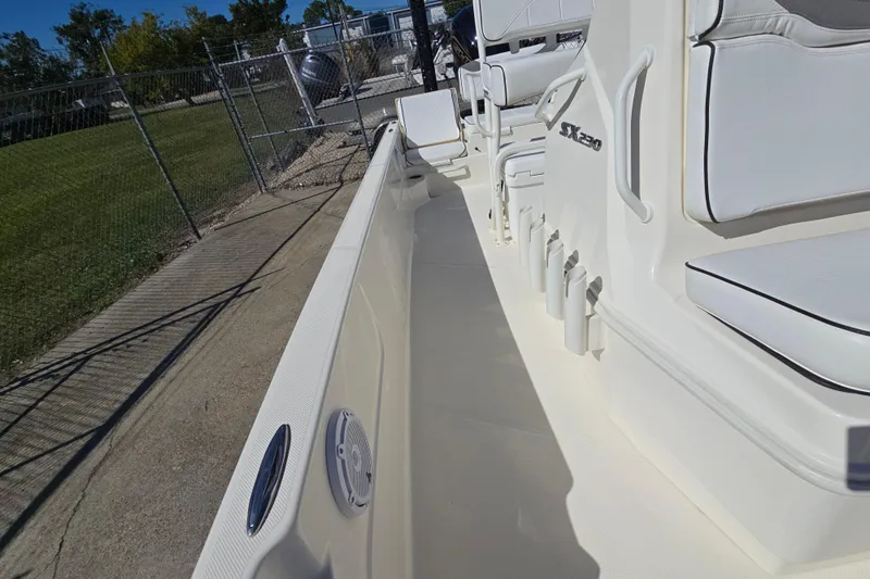 Slide: The Image of 2023 Skeeter SX230 boat interior with white seating and storage compartments. - 22