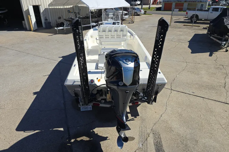 Slide: The Image of 2023 Skeeter SX230 boat with powerful outboard motor, parked outdoors. - 4