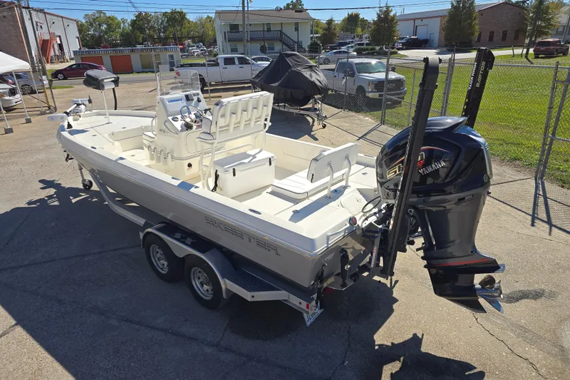 Slide: The Image of 2023 Skeeter SX230 boat on trailer with Yamaha engine, parked outdoors. - 5
