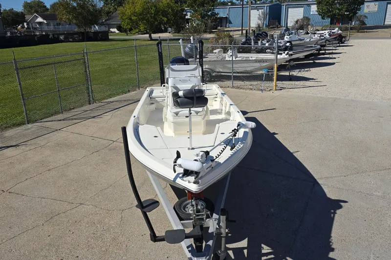 Slide: The Image of 2023 Skeeter SX230 boat on trailer in outdoor lot, surrounded by other boats. - 9