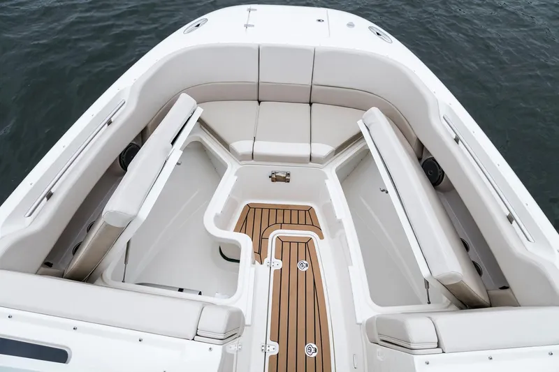 Slide: The Image of Manufacturer Provided Image: 2021 Boston Whaler 320 Vantage boat interior with cushioned seating and teak flooring. - 11