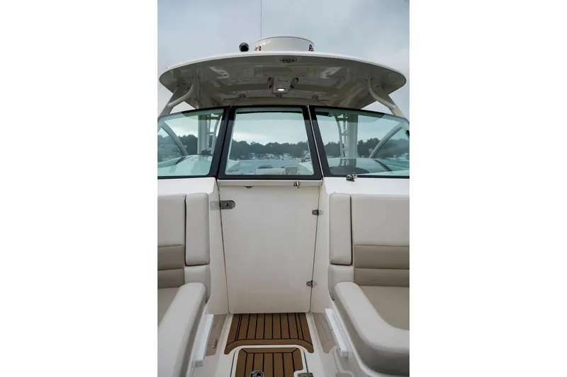 Slide: The Image of Manufacturer Provided Image: 2021 Boston Whaler 320 Vantage boat interior with seating and cabin door. - 12