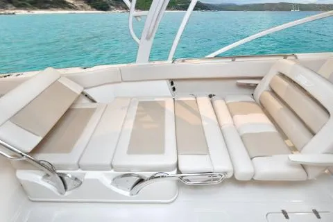 Slide: The Image of Manufacturer Provided Image: 2021 Boston Whaler 320 Vantage boat interior with beige seating, overlooking turquoise water. - 14