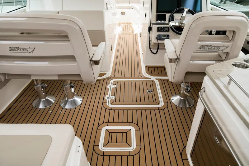 Slide: The Image of Manufacturer Provided Image: 2021 Boston Whaler 320 Vantage boat interior with teak flooring and dual captain chairs. - 18
