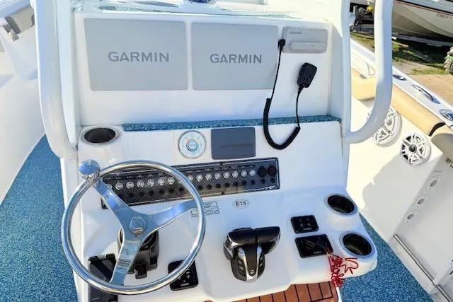 Slide: The Image of 2021 Tidewater 292 CC Adventure boat console with Garmin displays and steering wheel. - 11