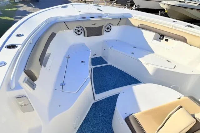 Slide: The Image of 2021 Tidewater 292 CC Adventure boat interior with seating and blue flooring. - 14