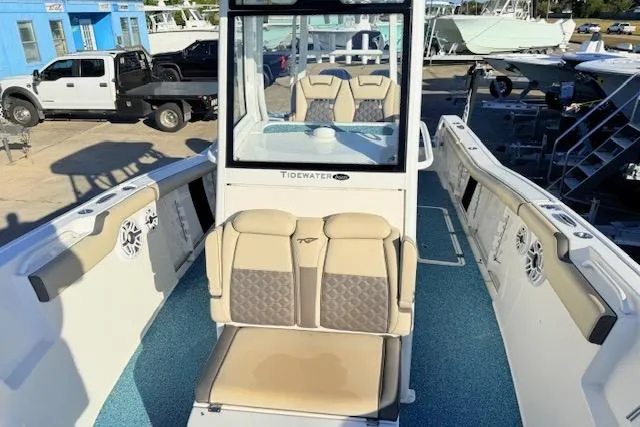 Slide: The Image of 2021 Tidewater 292 CC Adventure boat interior with beige seating and blue flooring. - 18