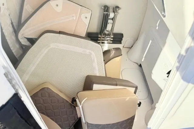 Slide: The Image of 2021 Tidewater 292 CC Adventure boat storage area with stacked cushions and equipment. - 19