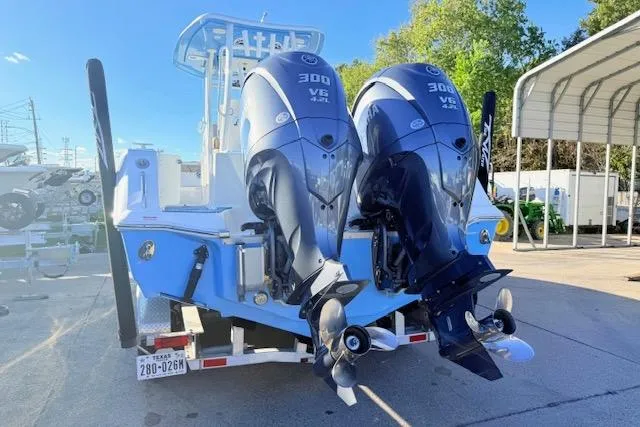 Slide: The Image of 2021 Tidewater 292 CC Adventure boat with dual 300 V6 engines, parked outdoors. - 3