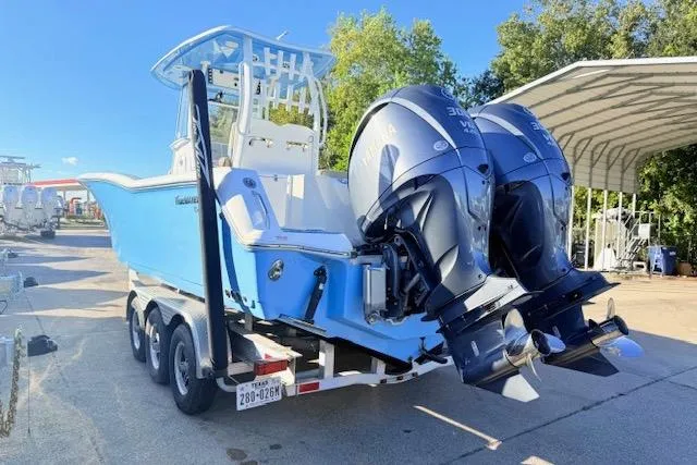 Slide: The Image of 2021 Tidewater 292 CC Adventure boat with dual engines on a trailer. - 4