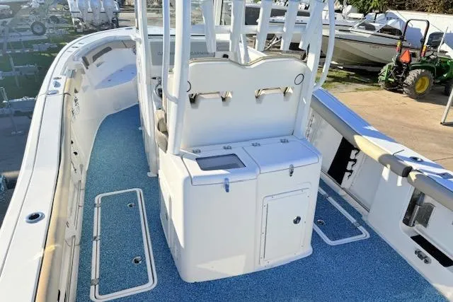 Slide: The Image of 2021 Tidewater 292 CC Adventure boat interior with blue deck and white console. - 6