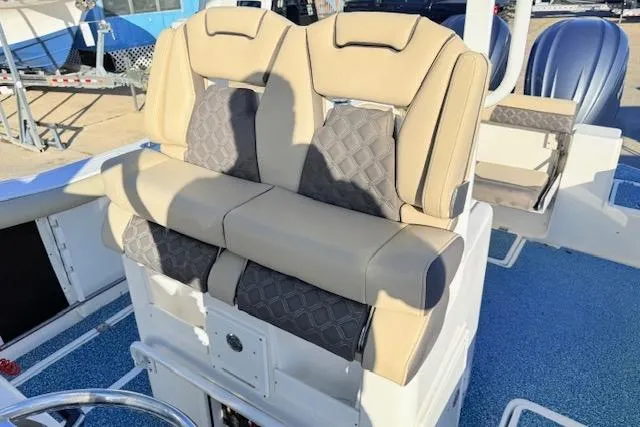 Slide: The Image of 2021 Tidewater 292 CC Adventure boat with beige and gray seating. - 9