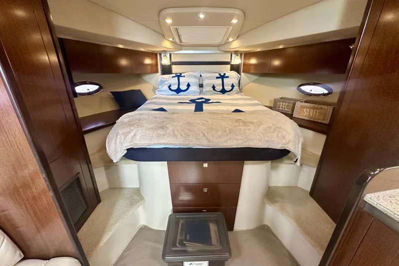 Slide: The Image of Luxurious 2011 Cruisers Yachts 420 Sports Coupe cabin with nautical-themed bedding. - 20