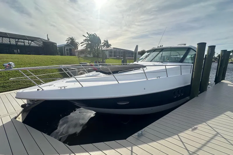Slide: The Image of 2011 Cruisers Yachts 420 Sports Coupe docked under a sunny sky. - 3