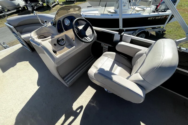 Slide: The Image of 2014 Starcraft Stardeck 190 Cruise boat interior with seating and steering console. - 16