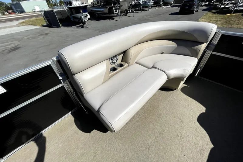 Slide: The Image of 2014 Starcraft Stardeck 190 Cruise pontoon boat interior with beige seating and steering console. - 19