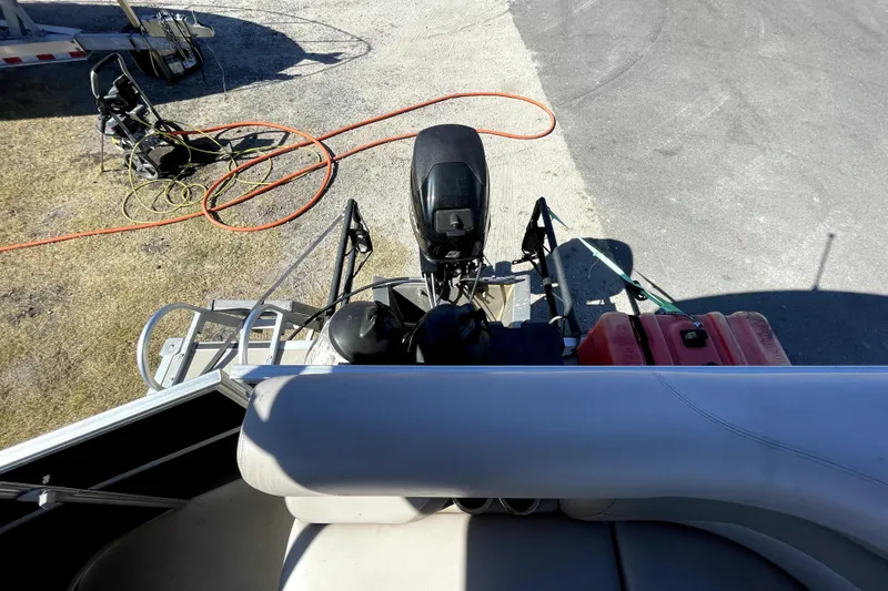 Slide: The Image of 2014 Starcraft Stardeck 190 Cruise pontoon boat interior with beige seating and helm. - 20