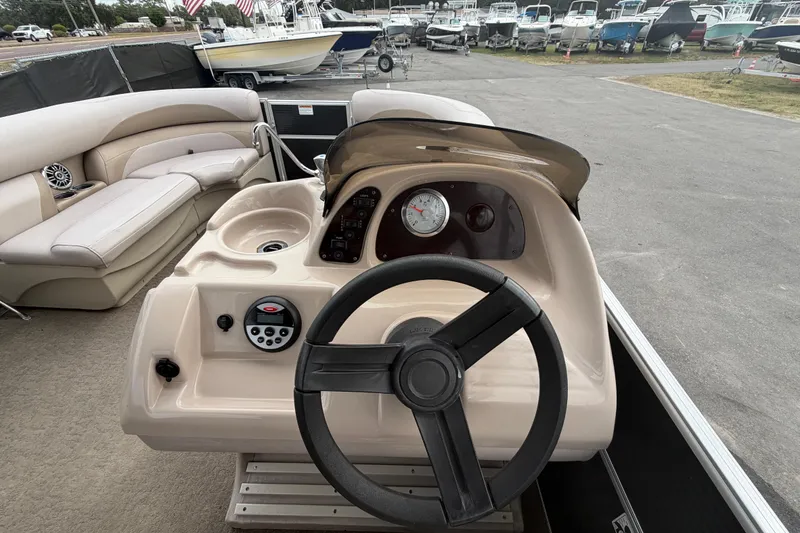 Slide: The Image of 2014 Starcraft Stardeck 190 Cruise boat interior with steering wheel and seating area. - 22
