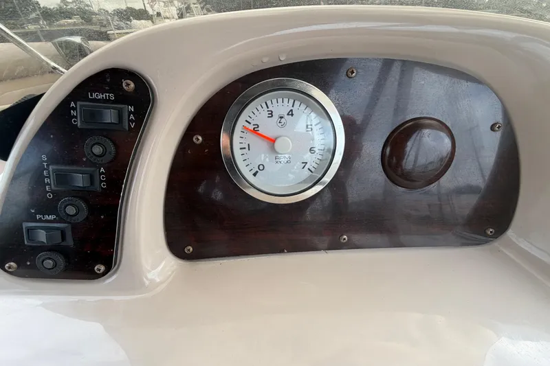 Slide: The Image of Dashboard of 2014 Starcraft Stardeck 190 Cruise boat with tachometer and control switches. - 24
