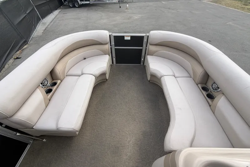 Slide: The Image of 2014 Starcraft Stardeck 190 Cruise boat interior with beige seating and cup holders. - 26