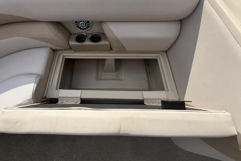 Slide: The Image of 2014 Starcraft Stardeck 190 Cruise boat seat storage compartment with cup holders and speaker. - 34