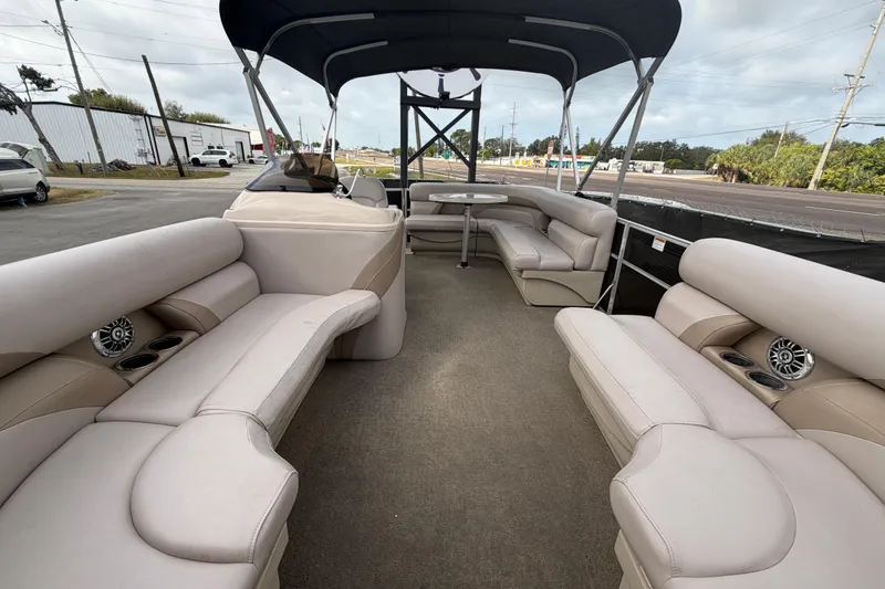 Slide: The Image of 2014 Starcraft Stardeck 190 Cruise pontoon boat interior with beige seating and canopy. - 37