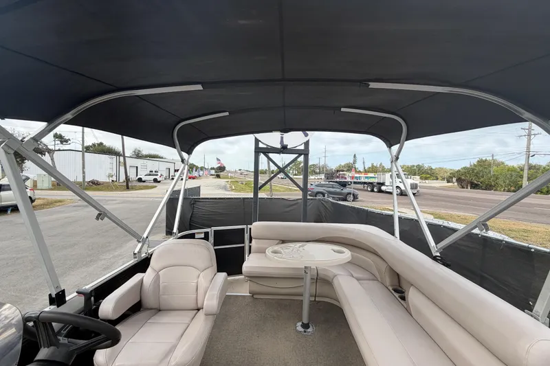 Slide: The Image of 2014 Starcraft Stardeck 190 Cruise interior with seating and canopy, parked outdoors. - 41