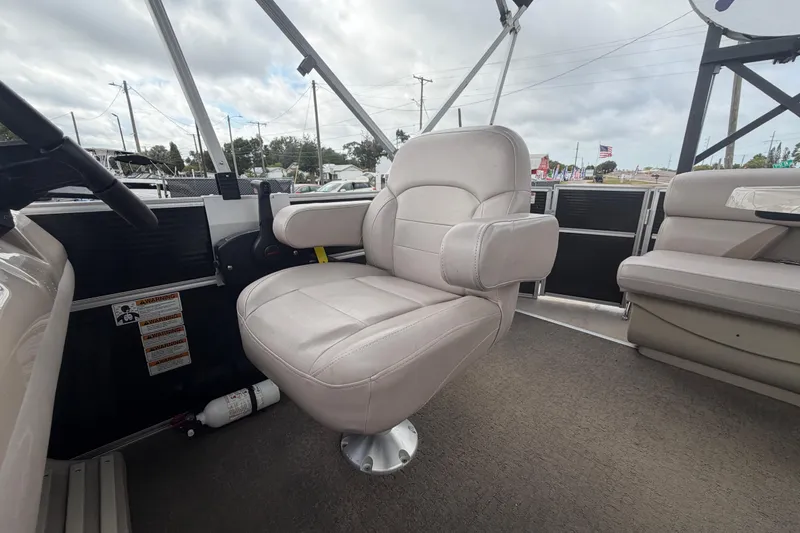 Slide: The Image of 2014 Starcraft Stardeck 190 Cruise boat interior with plush seating and steering area. - 43
