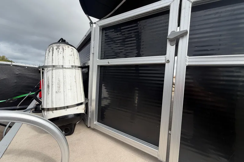 Slide: The Image of 2014 Starcraft Stardeck 190 Cruise boat with black paneling and equipment. - 53