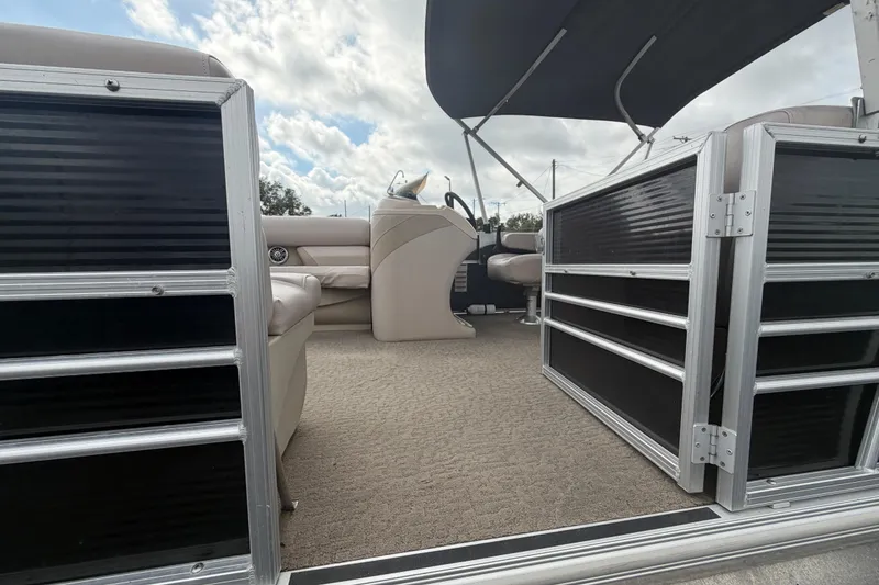 Slide: The Image of 2014 Starcraft Stardeck 190 Cruise interior with seating and canopy under cloudy sky. - 58