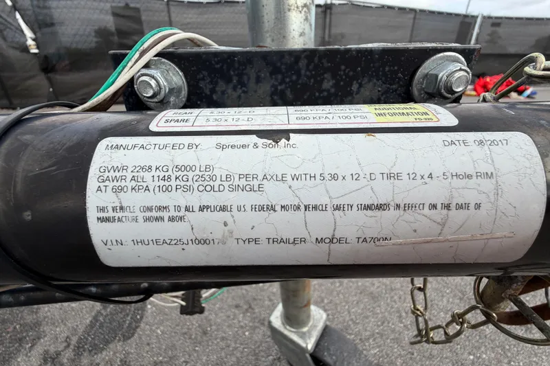Slide: The Image of Label on trailer hitch detailing specifications and compliance information, including weight and tire details. - 61
