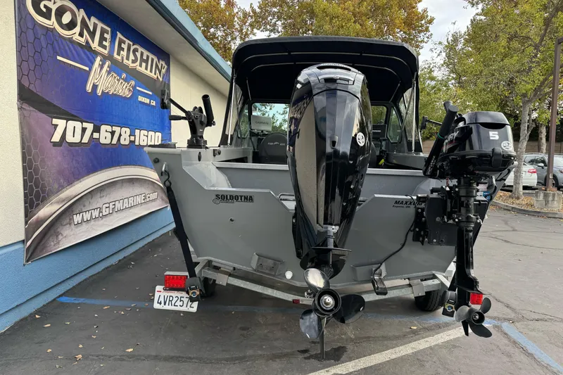 Slide: The Image of 2018 Fish Rite 16.5 Stalker boat with dual outboard motors at dealership. - 10