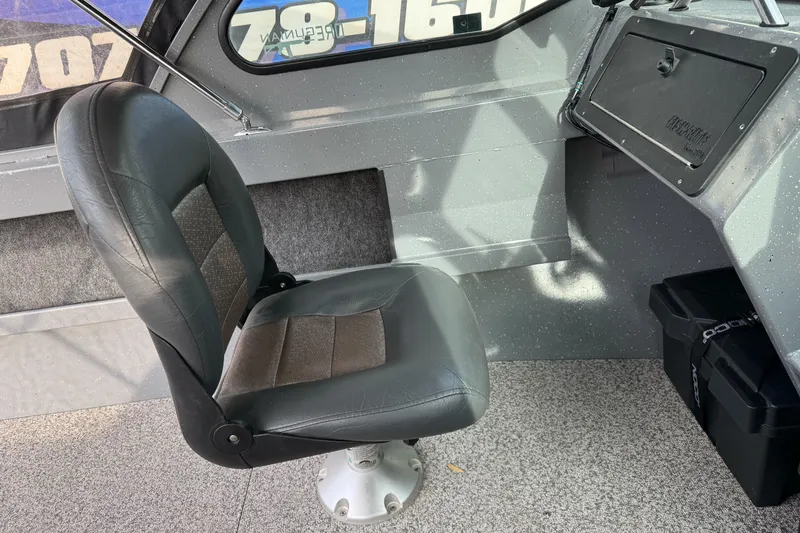 Slide: The Image of 2018 Fish Rite 16.5 Stalker boat interior with a cushioned seat and dashboard. - 19