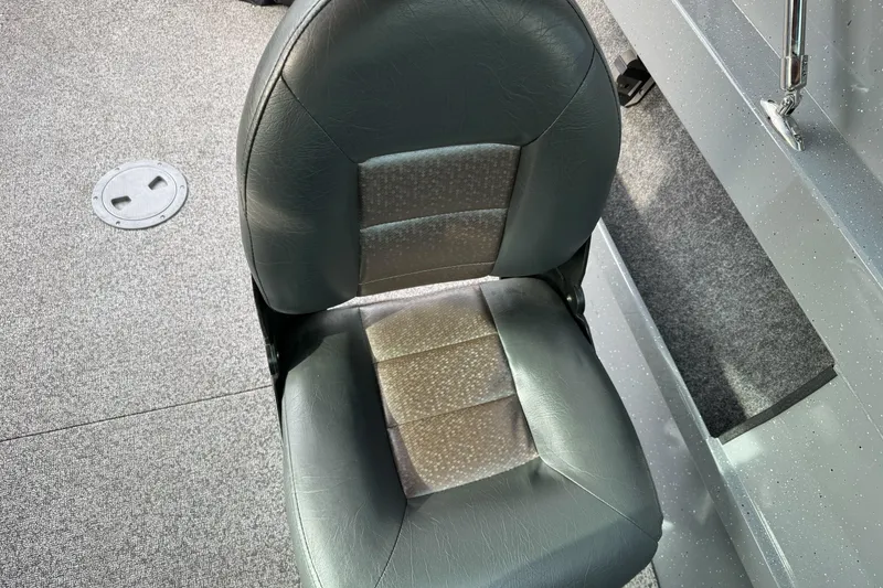 Slide: The Image of 2018 Fish Rite 16.5 Stalker boat seat, gray upholstery, carpeted floor. - 20