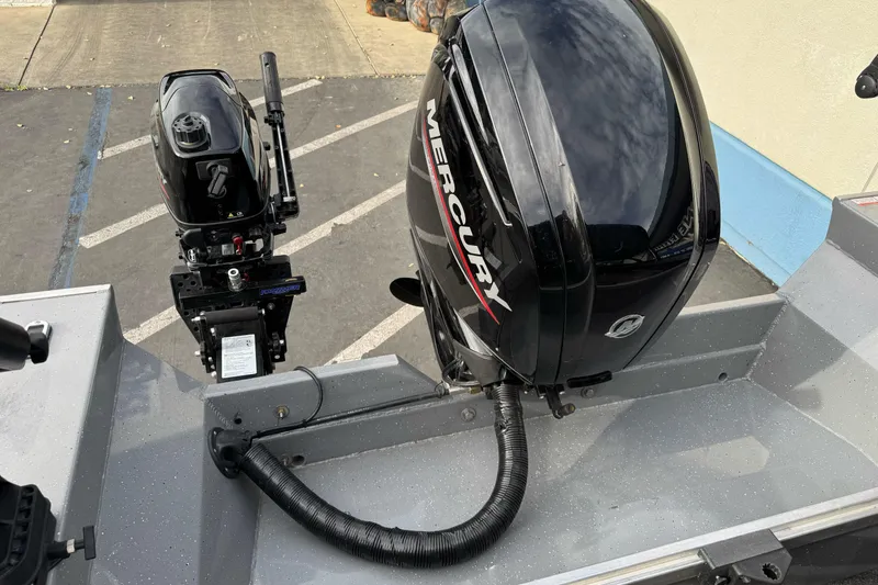 Slide: The Image of 2018 Fish Rite 16.5 Stalker boat with Mercury outboard motor in parking lot. - 5