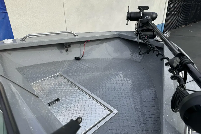 Slide: The Image of 2018 Fish Rite 16.5 Stalker boat deck with trolling motor and diamond plate flooring. - 8