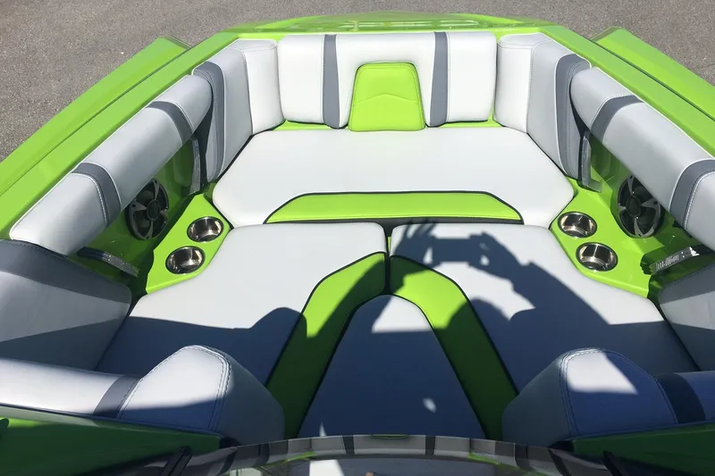 Slide: The Image of 2019 Malibu Wakesetter 21 MLX boat interior with green and gray seating. - 6