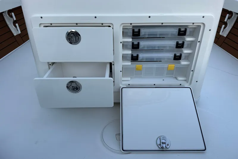 Slide: The Image of 2026 Pathfinder 2500 Hybrid boat storage compartments with drawers and tackle boxes. - 12