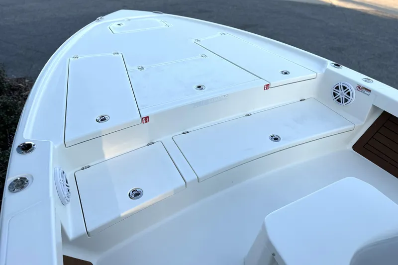 Slide: The Image of 2026 Pathfinder 2500 Hybrid boat deck with storage compartments and speakers. - 14