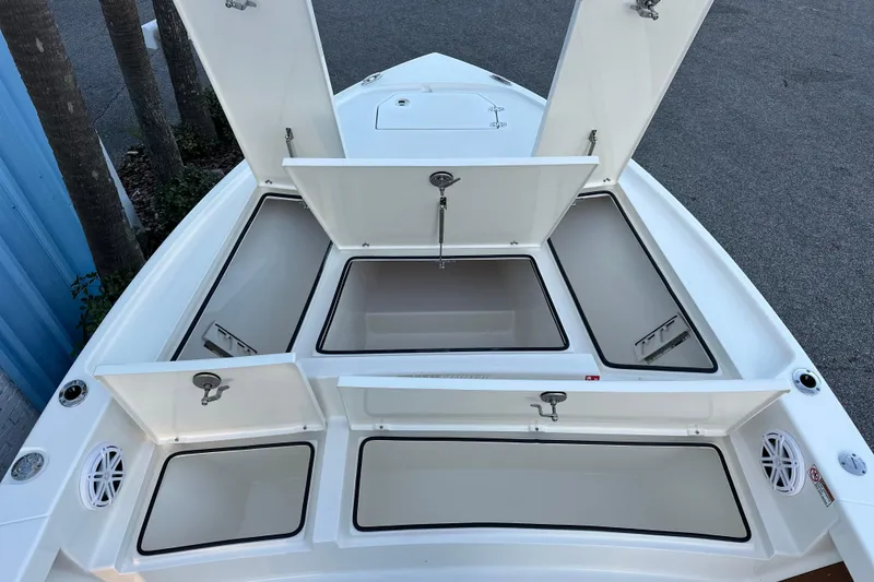 Slide: The Image of 2026 Pathfinder 2500 Hybrid boat with open storage compartments on deck. - 15