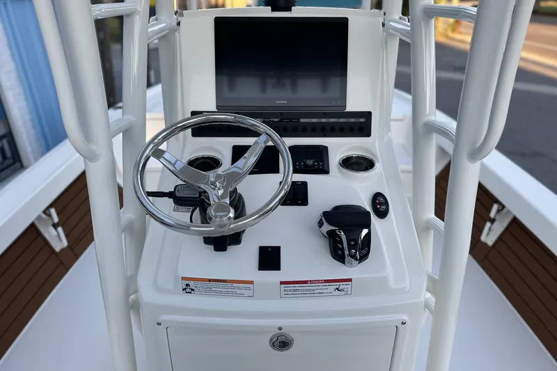Slide: The Image of 2026 Pathfinder 2500 Hybrid boat console with steering wheel and control panel. - 16