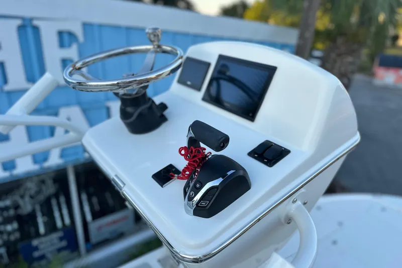 Slide: The Image of Control panel of 2026 Pathfinder 2500 Hybrid boat with steering wheel and digital displays. - 17