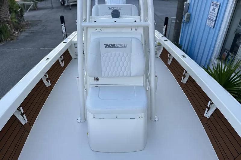 Slide: The Image of 2026 Pathfinder 2500 Hybrid boat interior with white seating and wood accents. - 19