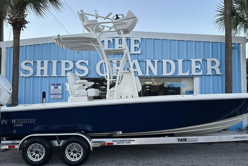 Slide: The Image of 2026 Pathfinder 2500 Hybrid boat on trailer outside The Ships Chandler store. - 3